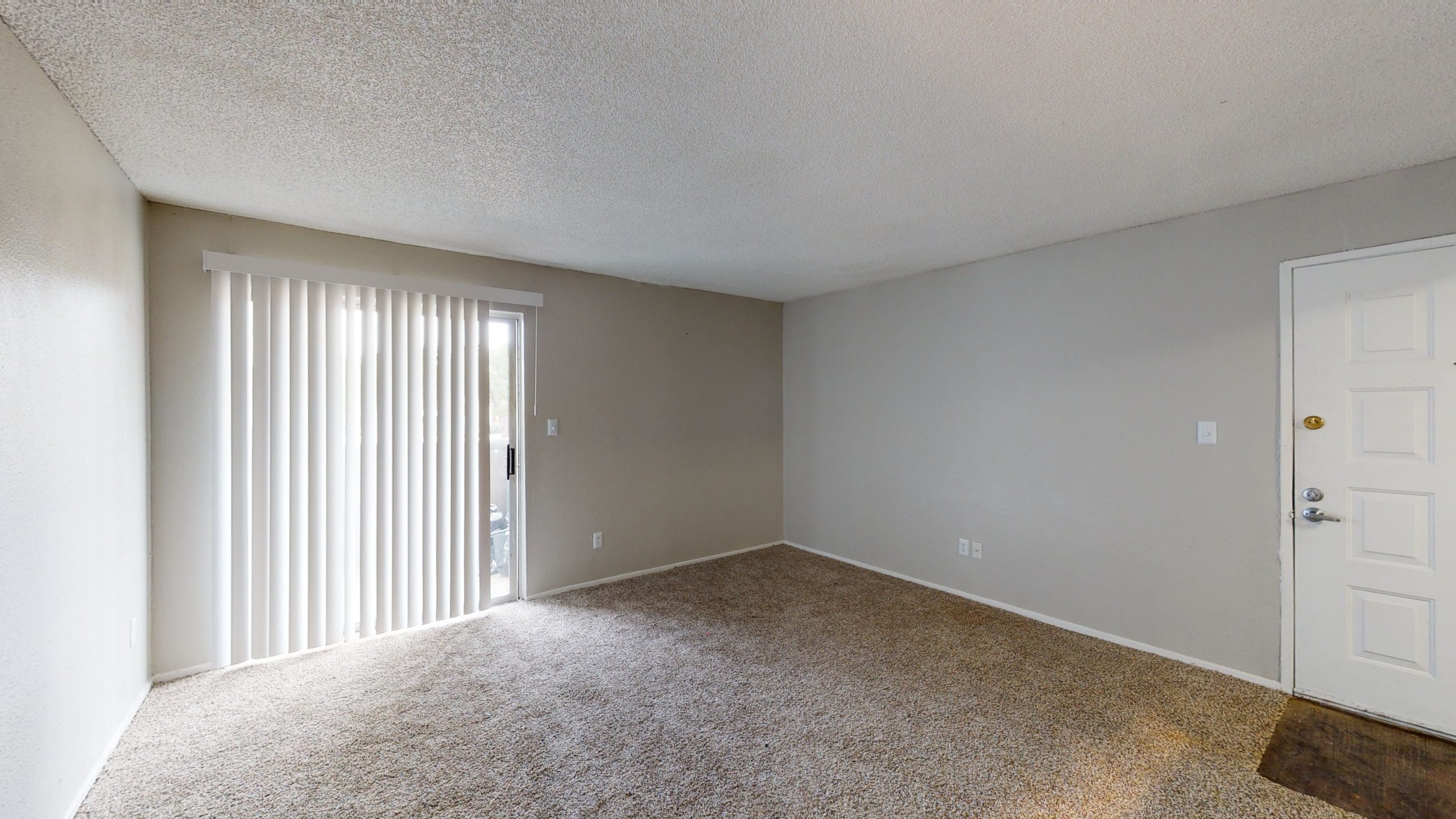 empty room with carpet and sliding glass doors at The  Mark at 2600