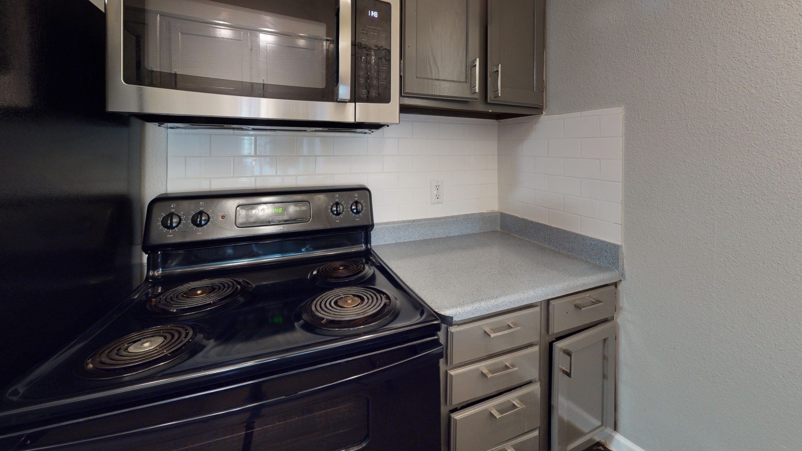 a kitchen with a stove and microwave oven at The  Mark at 2600