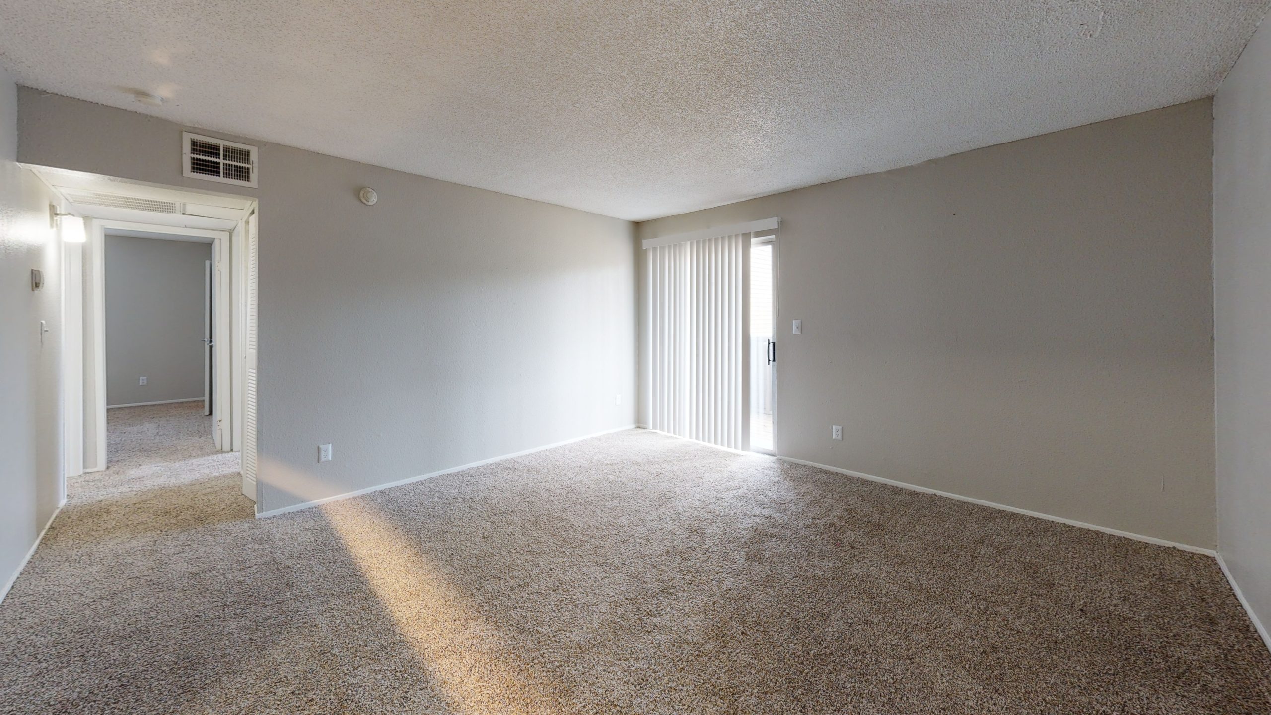 empty room with carpet and beige walls at The  Mark at 2600