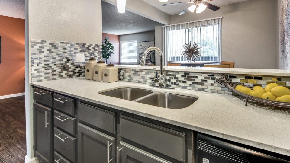 a kitchen with granite counter tops and stainless steel appliances at The  Mark at 2600