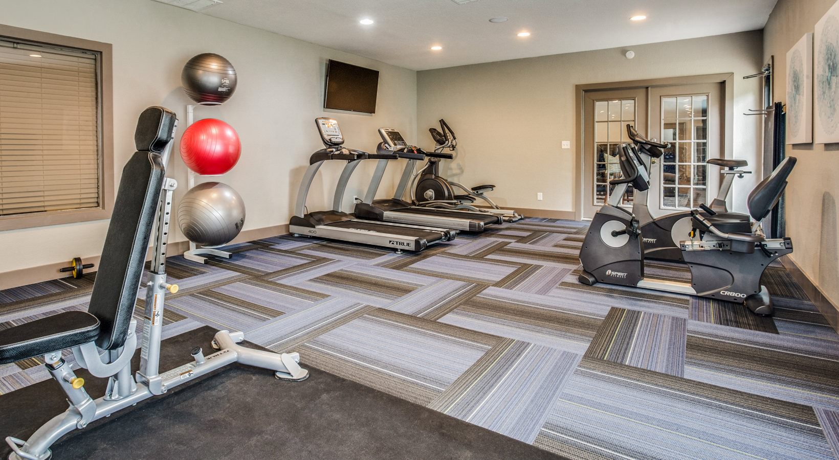 a gym room with exercise equipment and treads at The  Mark at 2600