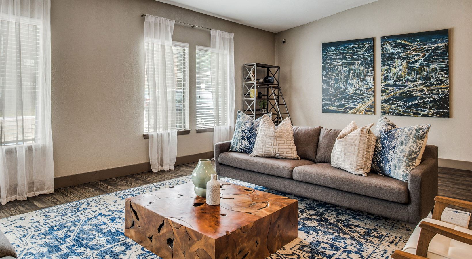 a living room with a blue rug and a coffee table at The  Mark at 2600