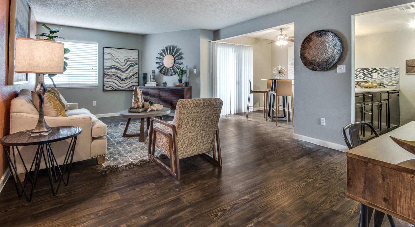 the living room has hardwood floors and a large dining table at The  Mark at 2600