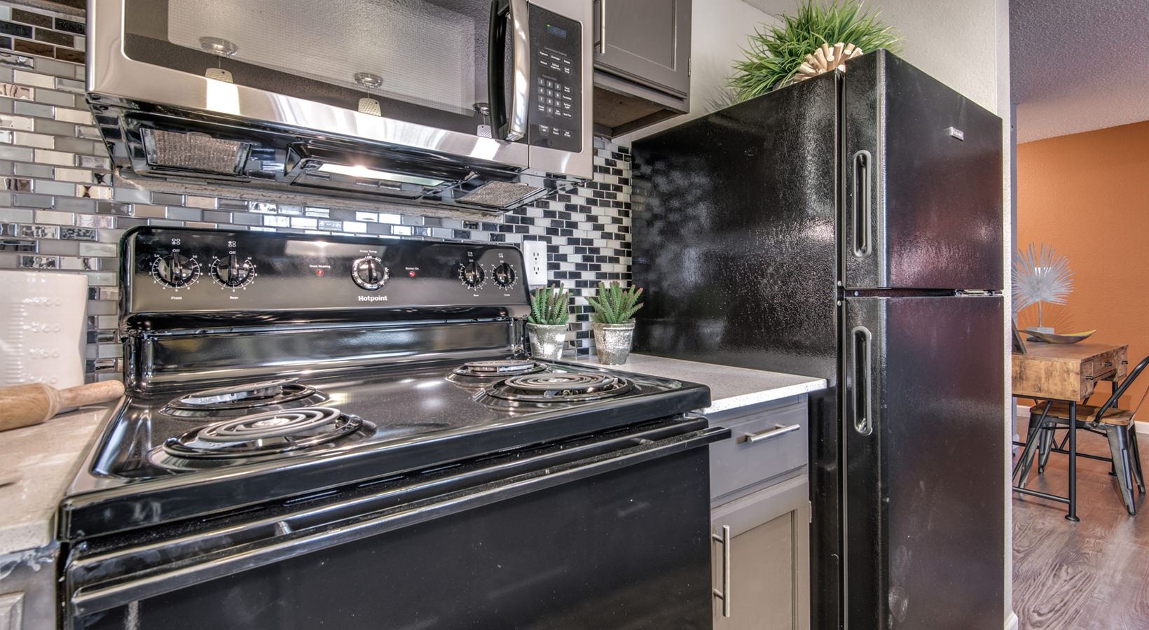 kitchen with black appliances and stainless steel stove at The  Mark at 2600