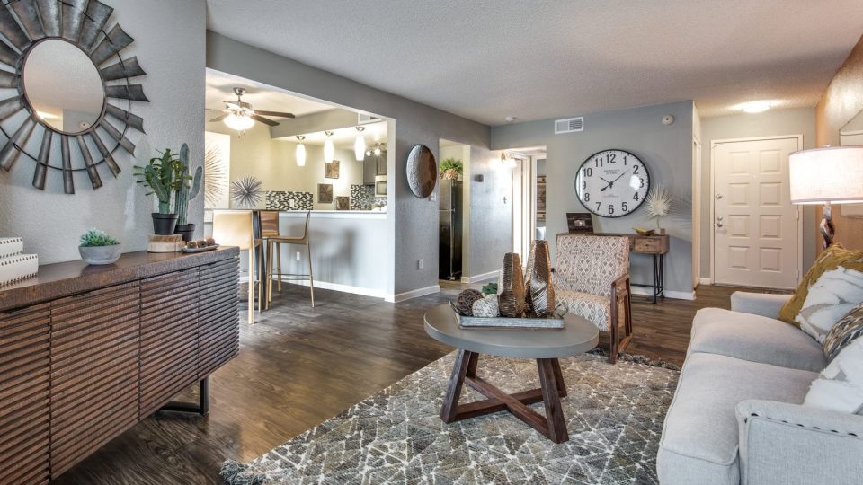 the living room has a large television and a coffee table at The Mark at 2600