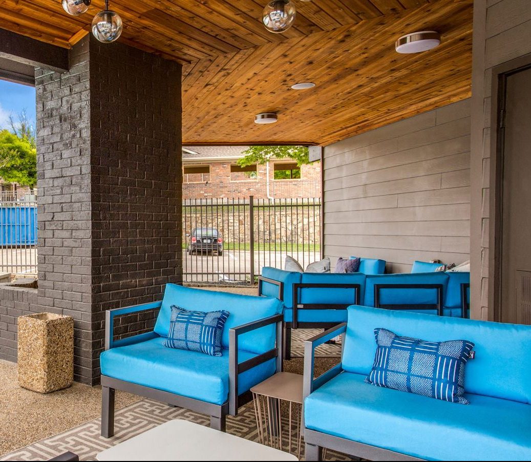 blue couches and chairs on the patio at The  Mark at 2600