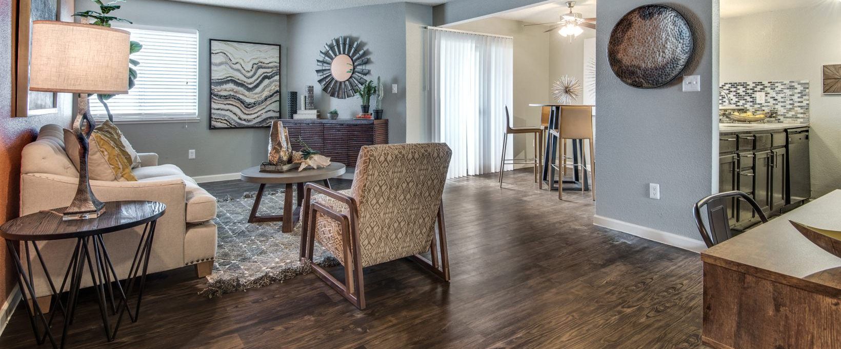 the living room has hardwood floors and a large dining table at The  Mark at 2600