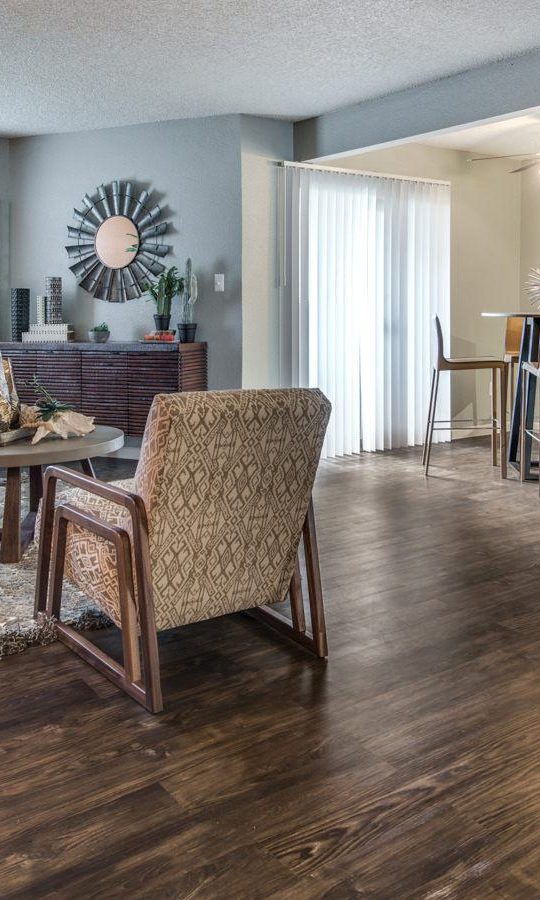 the living room has hardwood floors and a large dining table at The  Mark at 2600